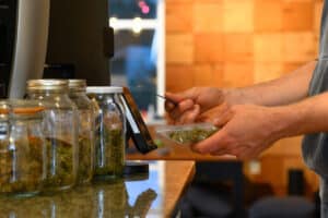 Paying by credit card for marijuana at a cannabis dispensary. Purchasing legal recreation drugs. Medical marijuana at a clinic.