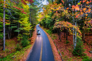 Cars drive in Acadia National Park in Maine, USA, in autumn.